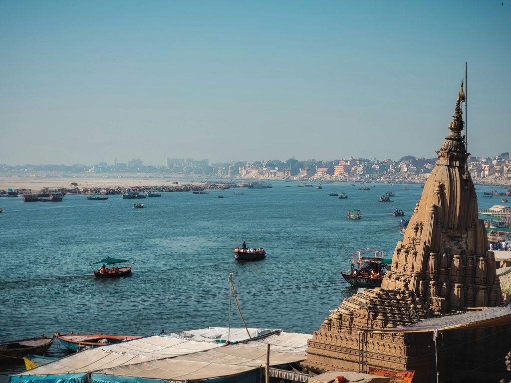 Beautiful view of the Ganges River in Varanasi with boats and historic architecture.